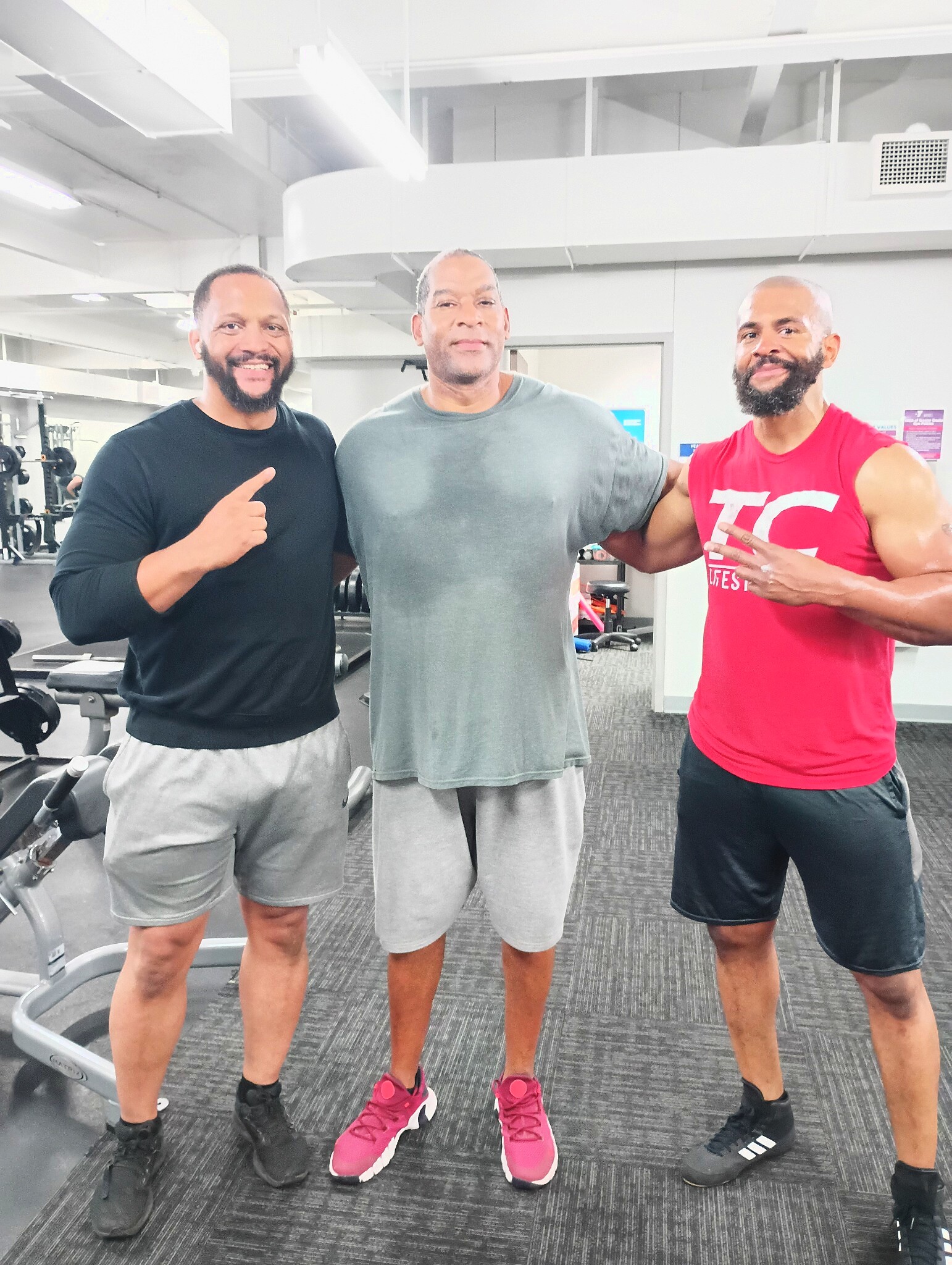Tim with two men in the gym